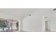 Bright open-concept living space with sliding glass doors to the pool and light wood-look floors at 2914 Dick Wilson Dr, Sarasota, FL 34240