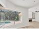 Bright living room view featuring a screened lanai, pool, and fireplace at 2914 Dick Wilson Dr, Sarasota, FL 34240