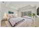 Comfortable main bedroom offering hardwood floors, a ceiling fan, and sliding glass doors to the pool area at 2914 Dick Wilson Dr, Sarasota, FL 34240