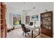 Bright home office complete with hardwood floors, a ceiling fan, and views of the manicured outdoor landscaping at 2914 Dick Wilson Dr, Sarasota, FL 34240