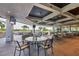 Inviting outdoor patio with golf course view, comfortable seating, and covered dining area at 2914 Dick Wilson Dr, Sarasota, FL 34240