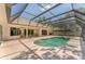 Wide angle shot of the in-ground pool with jacuzzi, screened in lanai, and seating area at 2914 Dick Wilson Dr, Sarasota, FL 34240