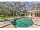 A close-up of the in-ground swimming pool and jacuzzi in the screened in lanai at 2914 Dick Wilson Dr, Sarasota, FL 34240