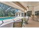 Screened in lanai with a swimming pool, outdoor kitchen, ceiling fan and ample seating area at 2914 Dick Wilson Dr, Sarasota, FL 34240