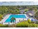 A stunning pool with sun loungers, umbrellas, and lush greenery, perfect for relaxation and recreation at 2914 Dick Wilson Dr, Sarasota, FL 34240