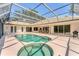 An wide angle shot of the pool and jacuzzi inside of the screened in lanai with access to the home at 2914 Dick Wilson Dr, Sarasota, FL 34240