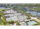 Overhead view of meticulously maintained tennis courts lined by trees and bushes at 2914 Dick Wilson Dr, Sarasota, FL 34240