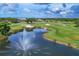 Picturesque golf course featuring a lake with a water fountain surrounded by lush greenery and sand traps at 2914 Dick Wilson Dr, Sarasota, FL 34240