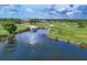 Scenic view of the golf course with a lake featuring a water fountain, lush fairways, and trees at 2914 Dick Wilson Dr, Sarasota, FL 34240