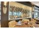 Intriguing wine display wall with glass doors, illuminated shelving, and adjacent dining area at 2914 Dick Wilson Dr, Sarasota, FL 34240