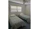 Bright bedroom with two twin beds, each with unique patterned bedding at 3060 Courtland St, Sarasota, FL 34237