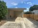 Attached carport with metal awning and concrete pad, offering convenient parking and shelter in residential setting at 3060 Courtland St, Sarasota, FL 34237
