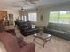 Bright living room with plush seating, ceiling fans and natural light at 3060 Courtland St, Sarasota, FL 34237