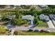 Aerial view of a well-maintained home with mature trees, and street parking at 3468 Roslyn Rd, Venice, FL 34293