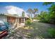 Large backyard featuring mature trees, a screened in area, and outdoor recreational space at 3468 Roslyn Rd, Venice, FL 34293