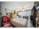 Comfortable bedroom featuring a ceiling fan, white bedspread, and a large window at 3468 Roslyn Rd, Venice, FL 34293