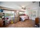 Cozy bedroom with tile flooring, ample natural light, and a unique bed featuring built-in storage at 3468 Roslyn Rd, Venice, FL 34293