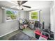 Bedroom featuring a ceiling fan, two windows for natural light, and neutral wall colors at 3468 Roslyn Rd, Venice, FL 34293