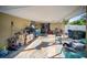 Spacious carport area with room for parking and storage, with various items at 3468 Roslyn Rd, Venice, FL 34293