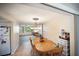 Bright dining room with a wooden table and chairs, open to the living area at 3468 Roslyn Rd, Venice, FL 34293