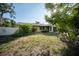 Charming home exterior featuring a well-maintained lawn, mature trees, and a cozy front porch at 3468 Roslyn Rd, Venice, FL 34293