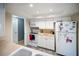 Functional kitchen with white cabinets, a microwave, an oven, and a refrigerator at 3468 Roslyn Rd, Venice, FL 34293