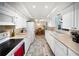 Efficient kitchen layout with white cabinets, a double sink, and modern appliances adjacent to the dining area at 3468 Roslyn Rd, Venice, FL 34293