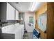 Functional laundry room with washer, dryer, and overhead cabinets for storage at 3468 Roslyn Rd, Venice, FL 34293