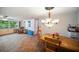Open-concept living and dining area with tile floors, a ceiling fan, and natural light at 3468 Roslyn Rd, Venice, FL 34293