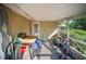 Covered patio or sunroom with various storage items and potential for outdoor seating at 3468 Roslyn Rd, Venice, FL 34293