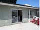The backyard features a sliding glass door that leads into the house and a concrete slab at 3646 Lakewood Dr, Sarasota, FL 34232