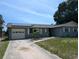 Charming single-story home with solar panels, well-maintained lawn and an attached garage at 3646 Lakewood Dr, Sarasota, FL 34232