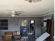 Messy living room shows signs of disrepair and neglect with clutter and damaged walls at 3646 Lakewood Dr, Sarasota, FL 34232