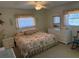Comfortable bedroom with floral bedding and a view to the outside at 3673 Somerville Dr # 1510, Sarasota, FL 34232