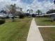 Well-manicured community featuring lush lawns, mature trees, and a walking path at 3673 Somerville Dr # 1510, Sarasota, FL 34232