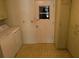 Functional laundry area featuring a washer, built-in cabinets, and a door to the outside at 3673 Somerville Dr # 1510, Sarasota, FL 34232