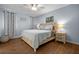 Comfortable bedroom with wood floors, ceiling fan, and a charming beach themed decor at 4076 Vana Dr, Sarasota, FL 34241