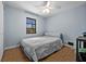 Bedroom with hardwood floors, ceiling fan and a window letting in natural light at 4076 Vana Dr, Sarasota, FL 34241