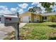 Quaint single-story home with an attached garage, well-maintained lawn, and welcoming curb appeal at 4076 Vana Dr, Sarasota, FL 34241