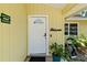 Welcoming front door with a 'Welcome' sign, and manicured plants adding charm at 4076 Vana Dr, Sarasota, FL 34241