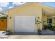 Attached garage with a white door and a welcoming front entrance with well-manicured plants at 4076 Vana Dr, Sarasota, FL 34241