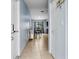 Hallway featuring tiled flooring and glimpses of the dining area, creating a bright interior at 4076 Vana Dr, Sarasota, FL 34241