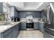 Updated kitchen featuring gray cabinets, stainless steel appliances, and ample counter space at 4076 Vana Dr, Sarasota, FL 34241