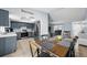 Open kitchen and dining area with stainless steel appliances and modern gray cabinets at 4076 Vana Dr, Sarasota, FL 34241