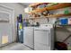 This laundry room includes a washer and dryer with shelves above for storage at 4076 Vana Dr, Sarasota, FL 34241