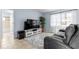Cozy living room with a plush gray rug, modern entertainment center, and bright natural light at 4076 Vana Dr, Sarasota, FL 34241