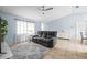 Bright living room with a gray couch, plush rug, and lots of natural light from the large window at 4076 Vana Dr, Sarasota, FL 34241