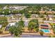 Suburban homes with mature trees with swimming pool on a sunny day at 4155 Center Gate Blvd, Sarasota, FL 34233