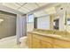 Bathroom with dual sinks, granite countertops, tile flooring, and tub with shower at 4155 Center Gate Blvd, Sarasota, FL 34233