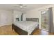 Bright bedroom featuring a ceiling fan, wood flooring, and a large window at 4155 Center Gate Blvd, Sarasota, FL 34233
